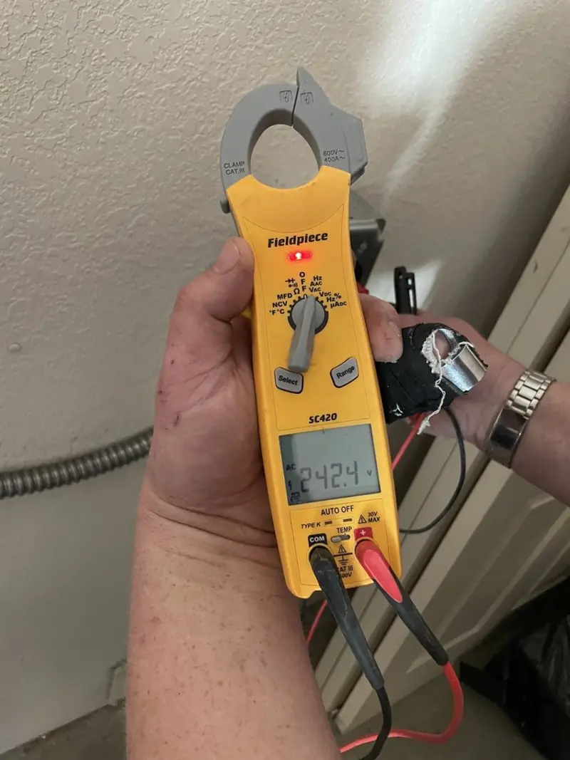 Voltage testing with clamp meter during Electrical Installation Services in Inverness